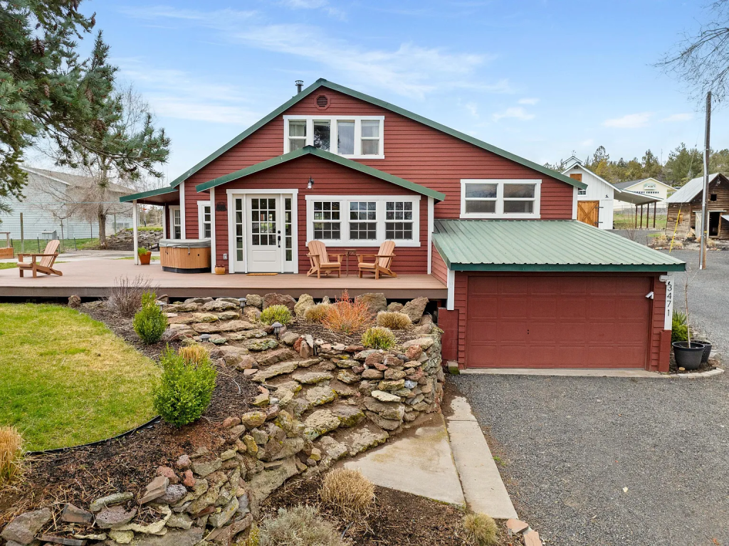 Our dream house nestled in Prineville, Oregon. A red, 1920's farmhouse with partial wraparound porch and beautiful landscaping surrounding it. 